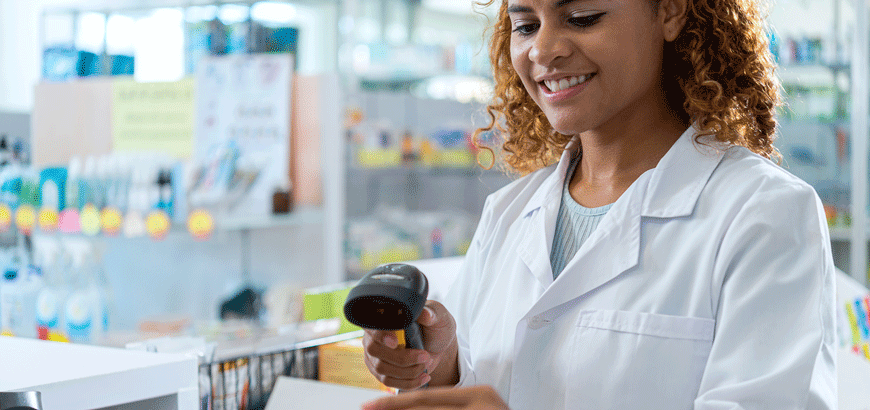 A female pharmacist uses a hand held scanner