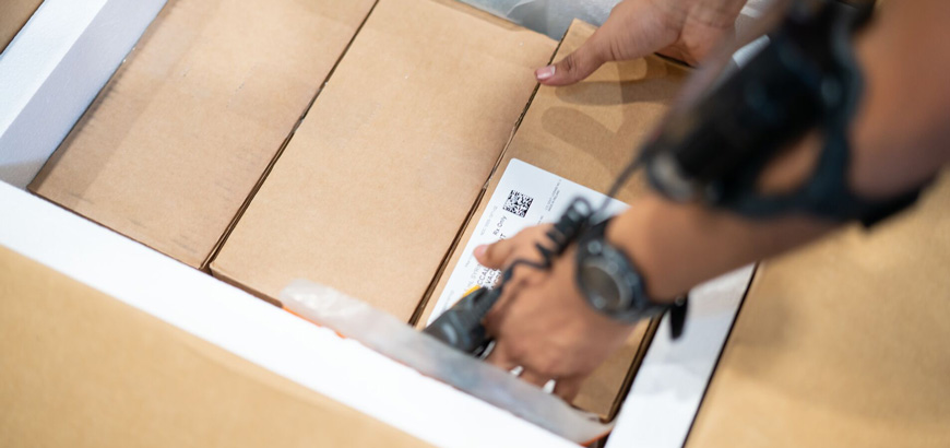 A distribution center working picking up a box.