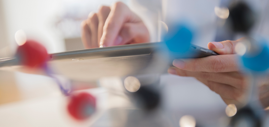 Close up of hands holding a tablet