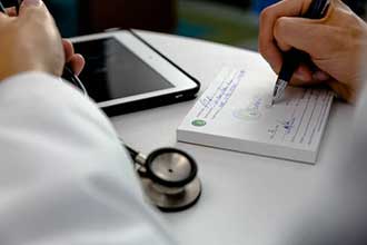 Doctor writing a prescription for a patient