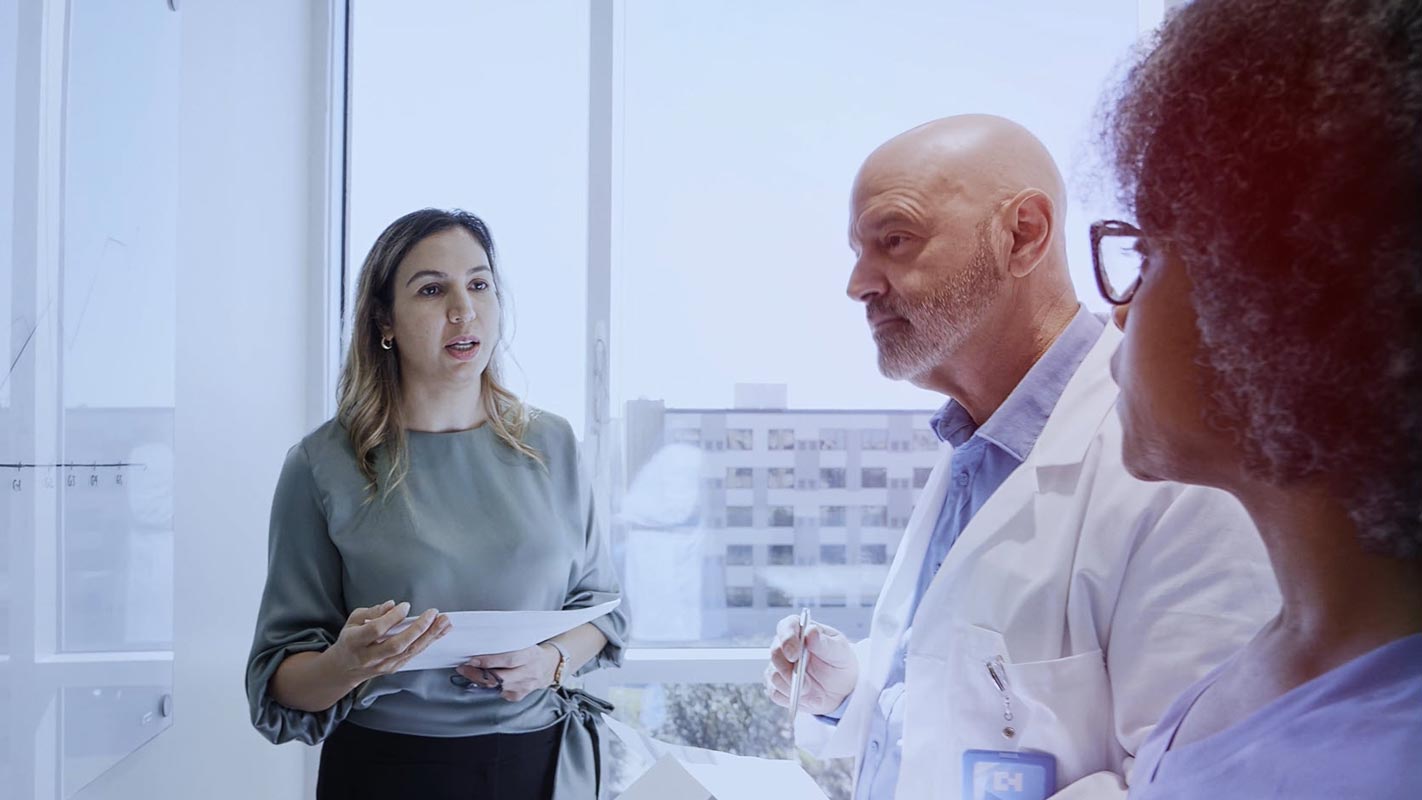 A woman speaking to coworkers