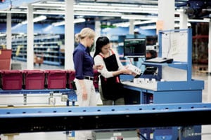 Two workers in warehouse double checking the supply chain<br>  <p> </p>  