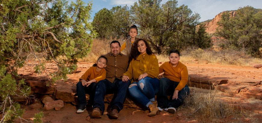 A family group photo outside in the desert