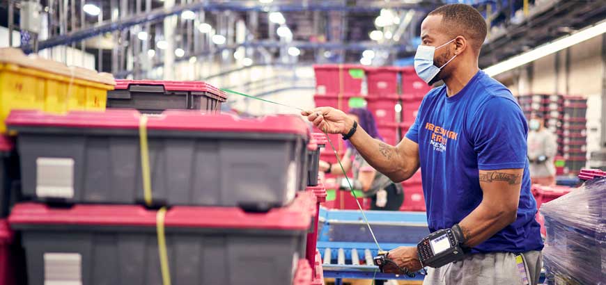 A worker securing shipping containers in a McKesson distribution center