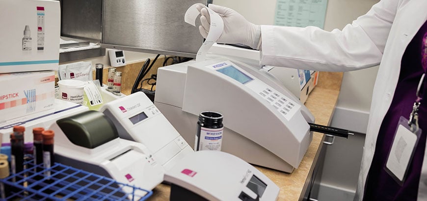 A pharmacist printing out a prescription