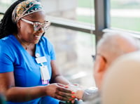 A nurse helping a patient