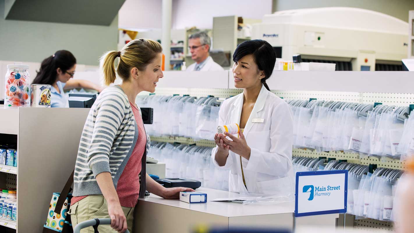 A pharmacist talking to a customer about a prescription