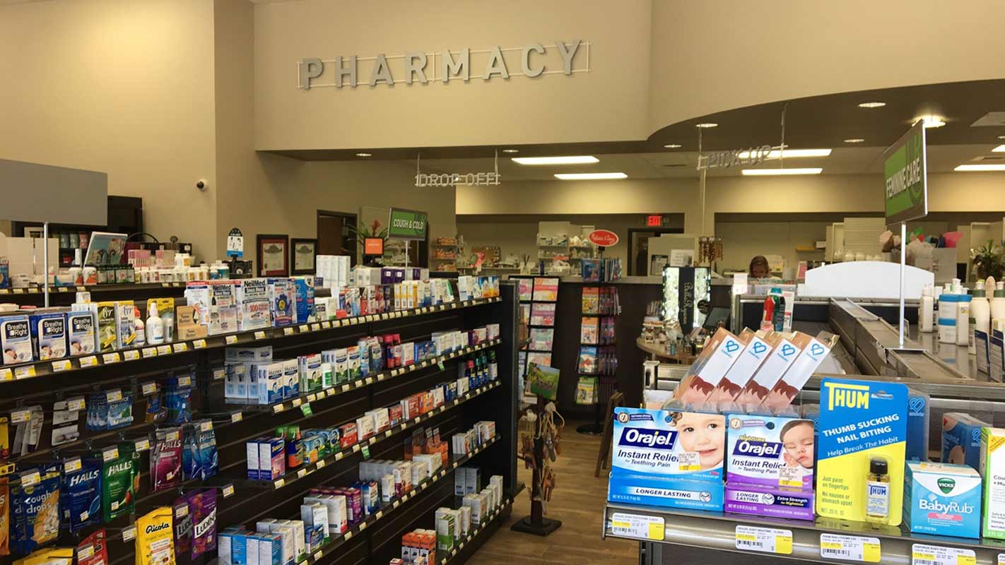 Interior of a pharmacy, showing aisles full of medications