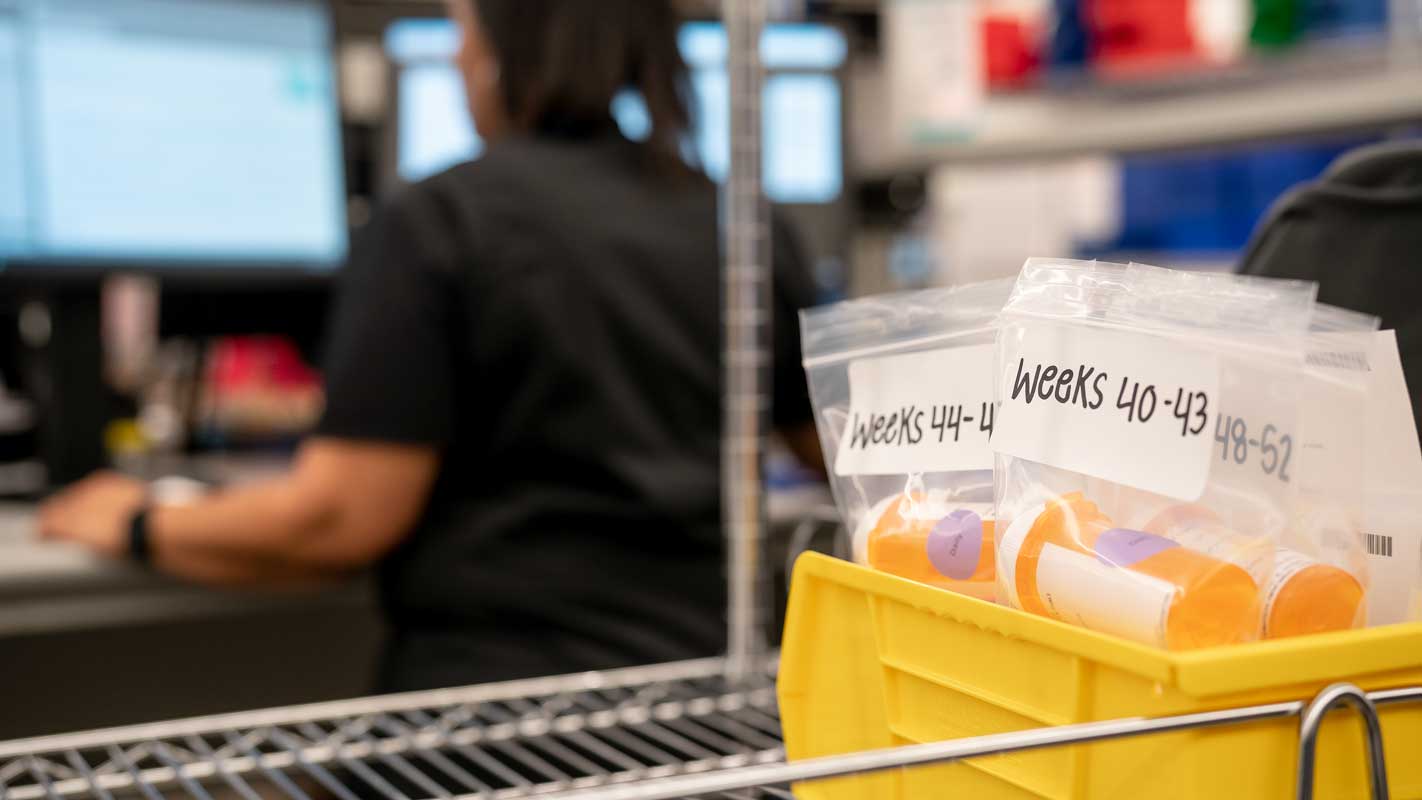 Medication bottles in ziploc bags with week numbers attached to them