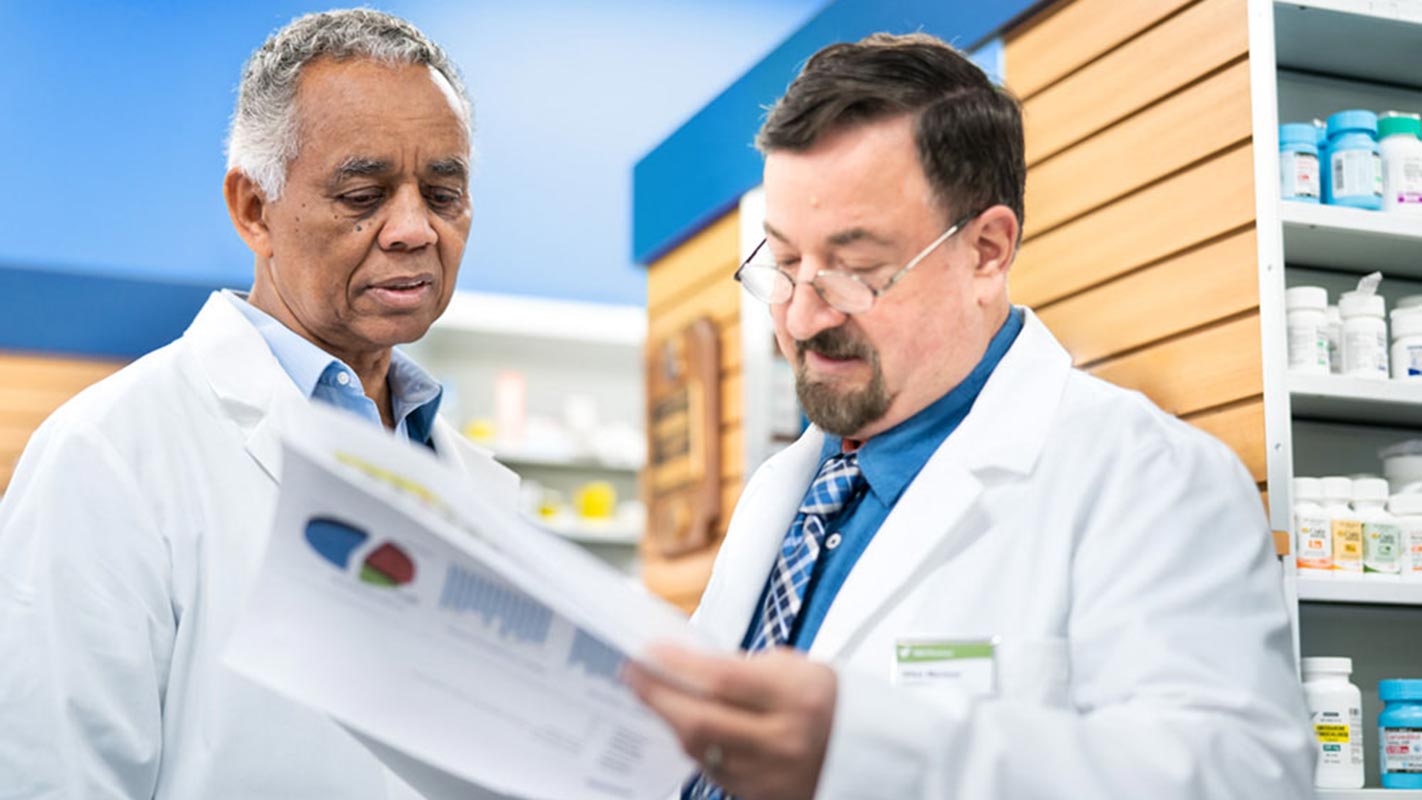 Two pharmacists reviewing a document