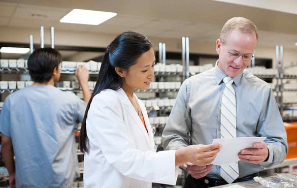 Two pharmacists review a prescription