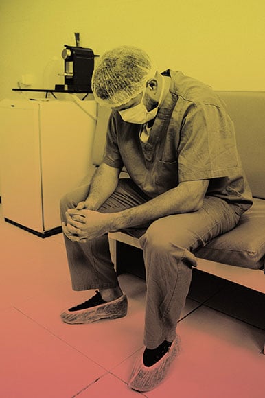 A fatigue healthcare worker sitting on a chair