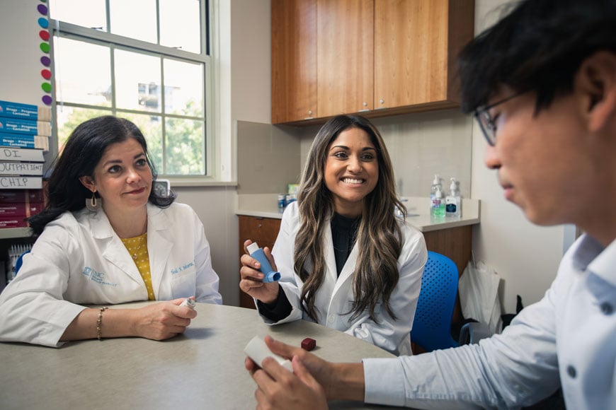 Pharmacy students practice with an inhaler