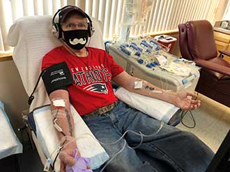 A man sitting in a chair donating blood