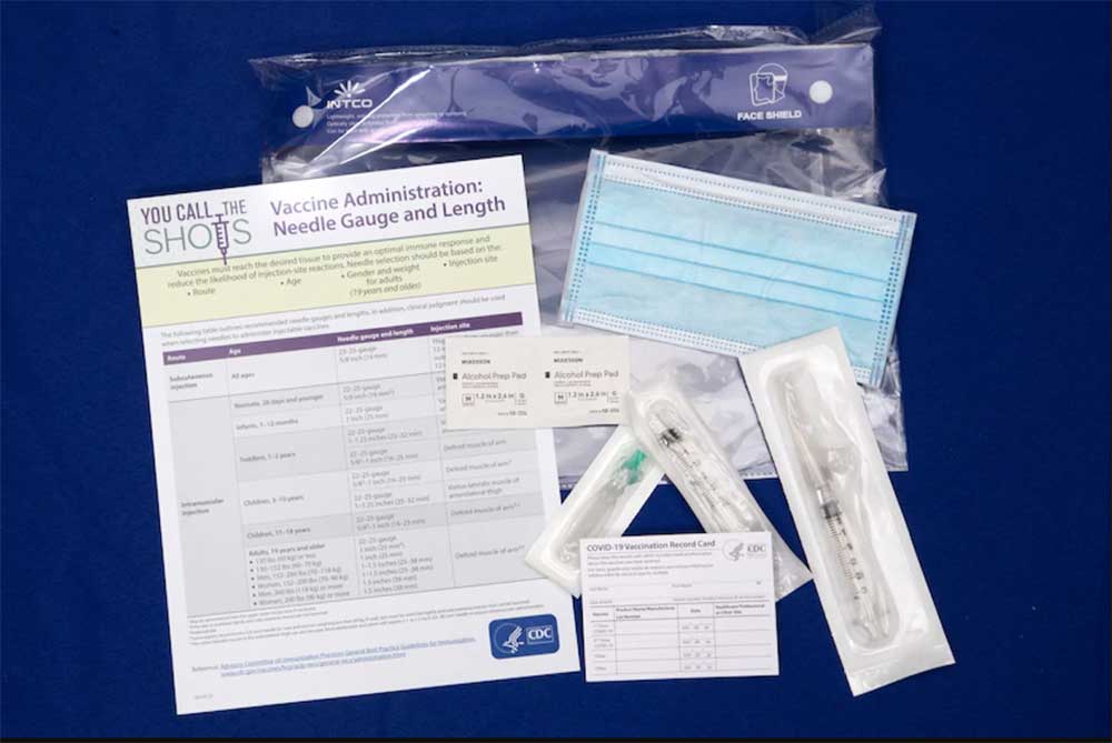 The contents of a COVID-19 vaccine kit lying on a table