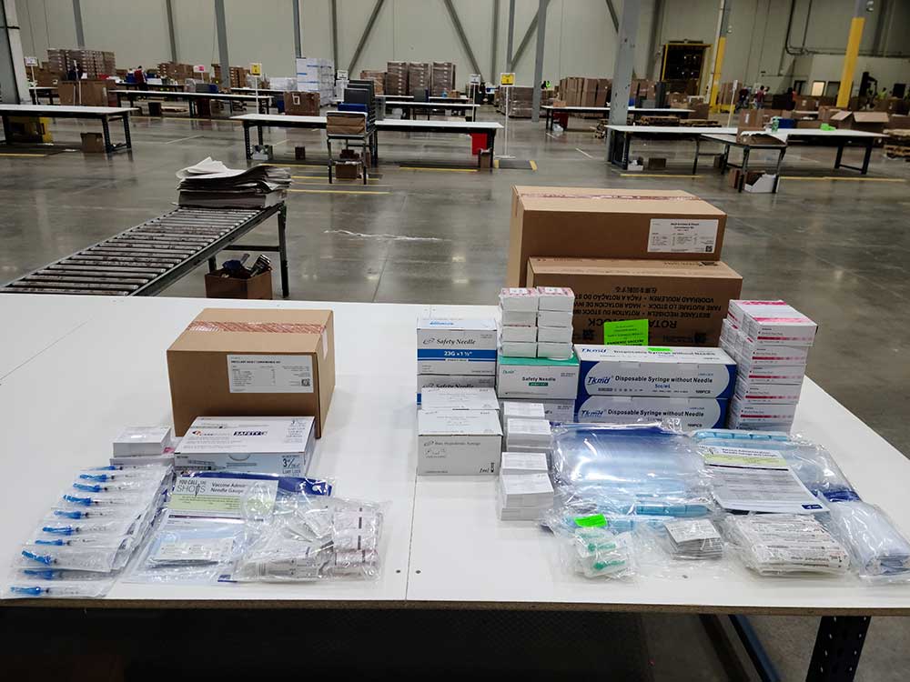 The contents of COVID-19 vaccine kits lying on a table